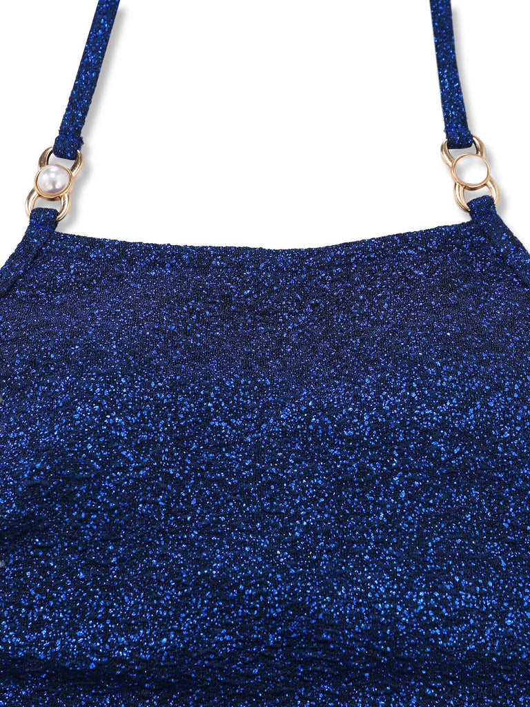 Close-up of the square neckline and gold-tone hardware on the shimmering navy blue fabric.