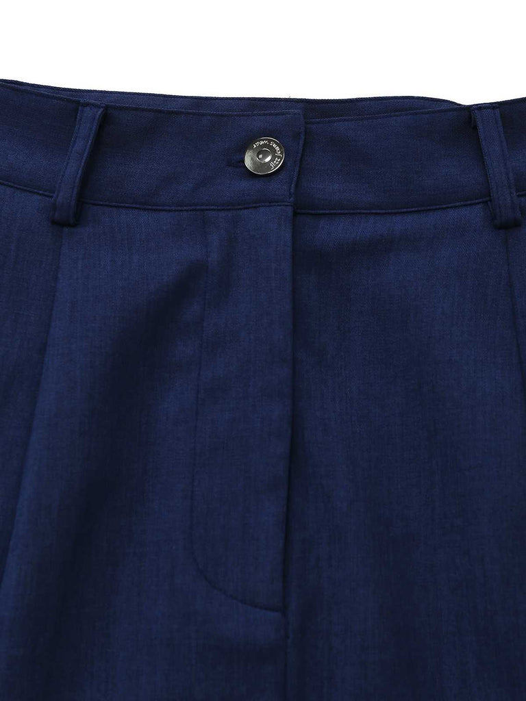 Close-up of the vertical pleat construction near the flared hem of the skirt.