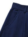 Detailed view of the functional integrated side-seam pocket on the navy blue skirt.