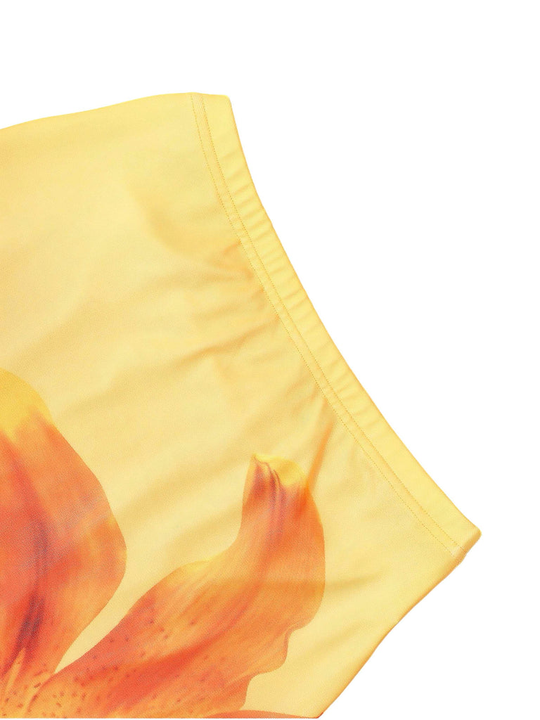 Close-up of the elasticated waistband on the yellow-and-orange floral print fabric.