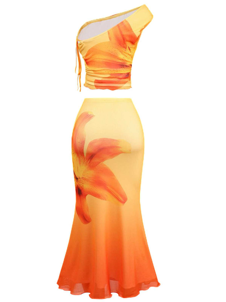 Rear view of the floral set showing the continuous orange-to-yellow gradient and the back construction of the one-shoulder top.