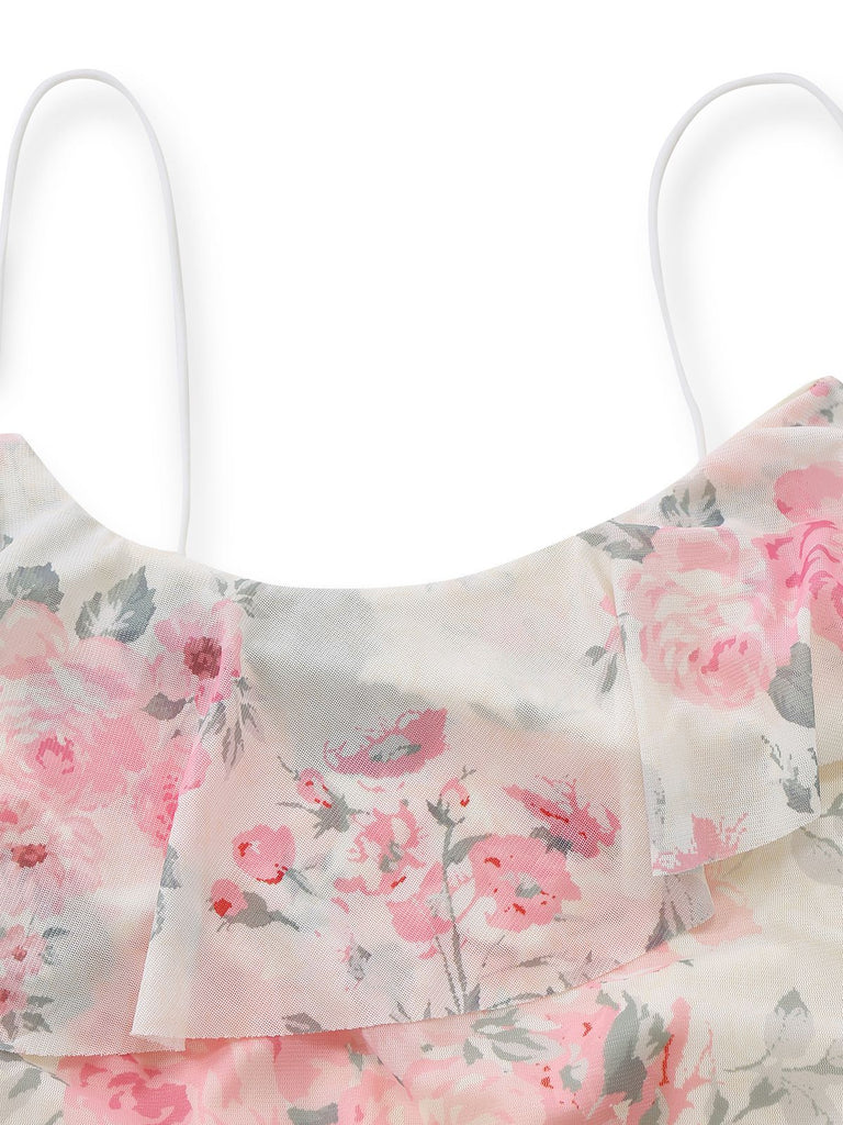 Close-up of the delicate white spaghetti strap and the layered ruffle detail on the dress neckline.