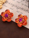 Boucles d'oreilles epoxy fleuries orange rétro